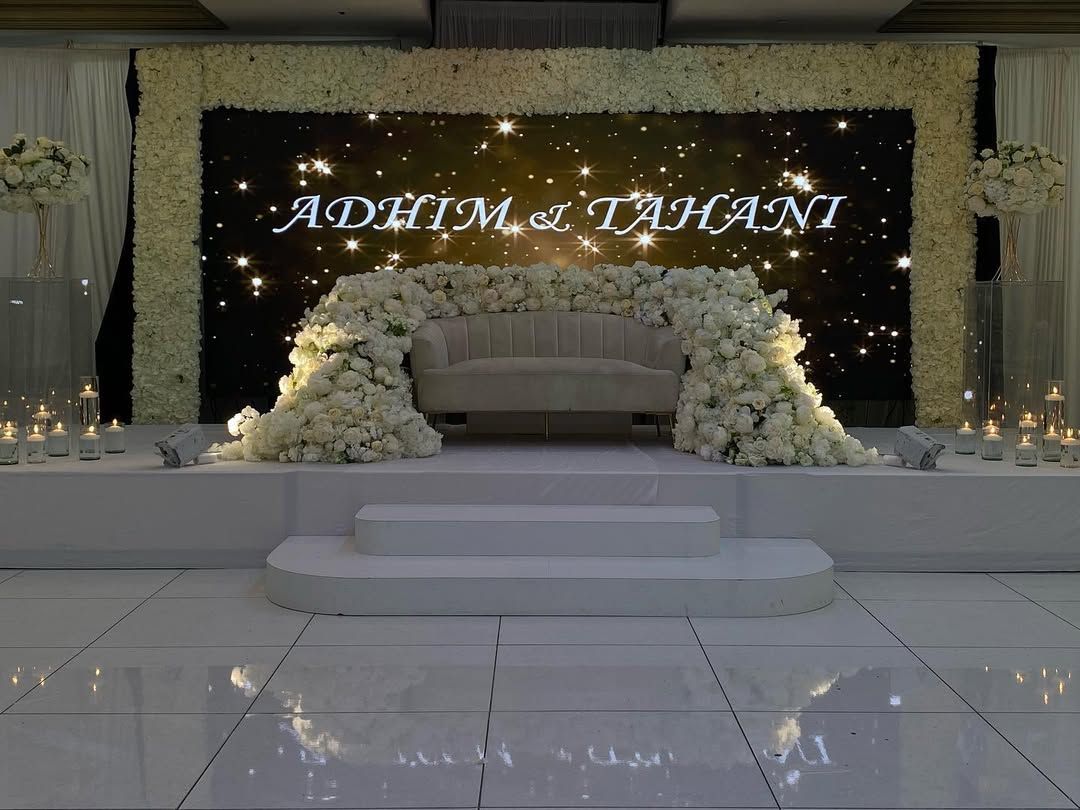 Wedding stage with starry backdrop and white flower arrangements