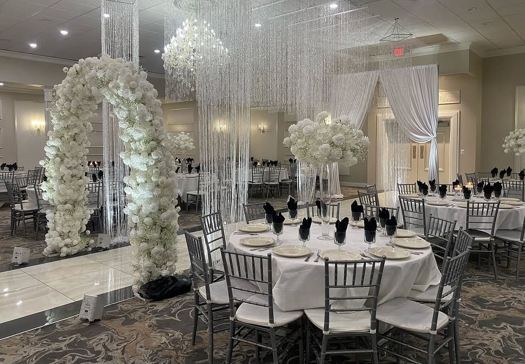 Elegant banquet hall with crystal chandeliers and white florals